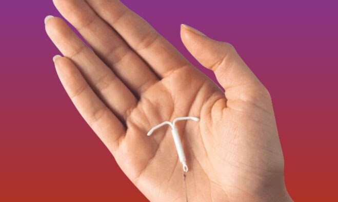 Hand holding an IUD